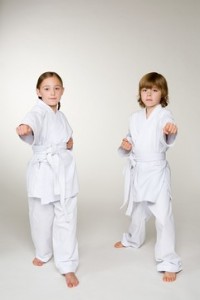 Two children doing karate punches